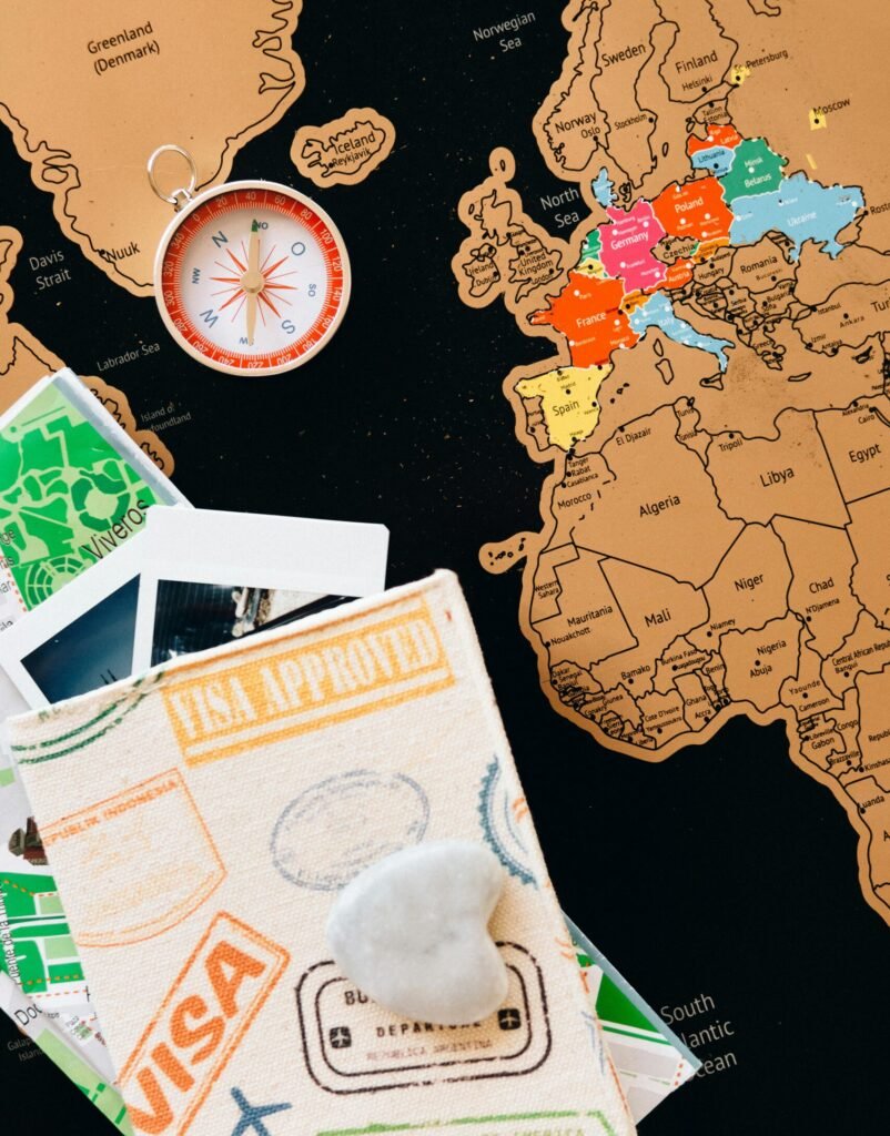 Explore the world with this colorful travel map, compass, and passport stamps.